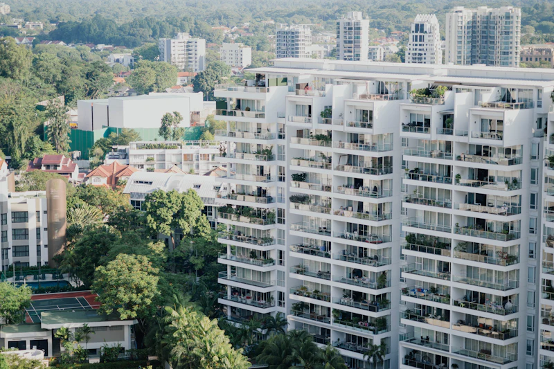 Modern apartment buildings with balconies surrounded by trees